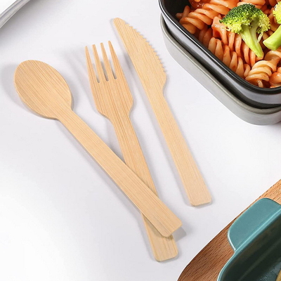 Le couteau jetable en bambou d'ensemble de vaisselle de matière première de couverts qui respecte l'environnement bifurque des cuillères